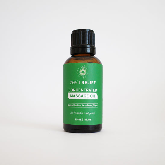 Bottle of ZEA RELIEF concentrated massage oil on a white background
